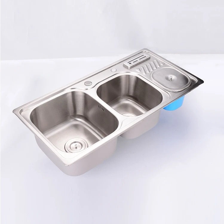Double bowl kitchen sink with knife and soap holder aside
